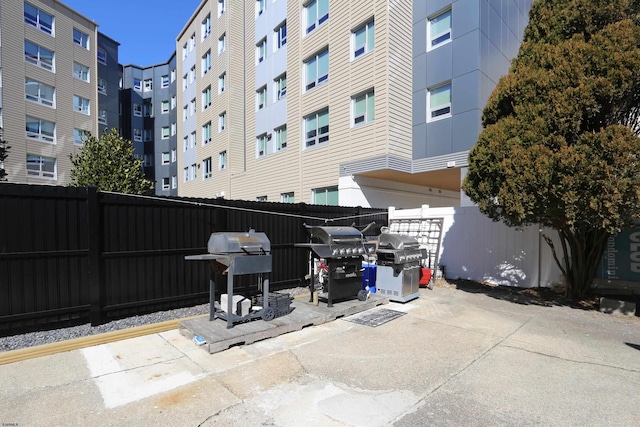 view of patio / terrace featuring a grill and fence