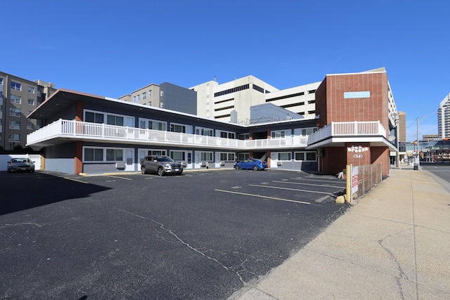 view of building exterior featuring uncovered parking