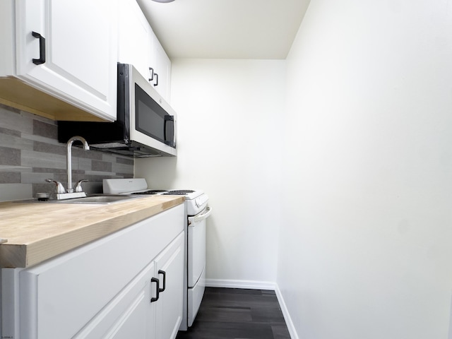 kitchen featuring a sink, white cabinets, white range with gas cooktop, tasteful backsplash, and stainless steel microwave