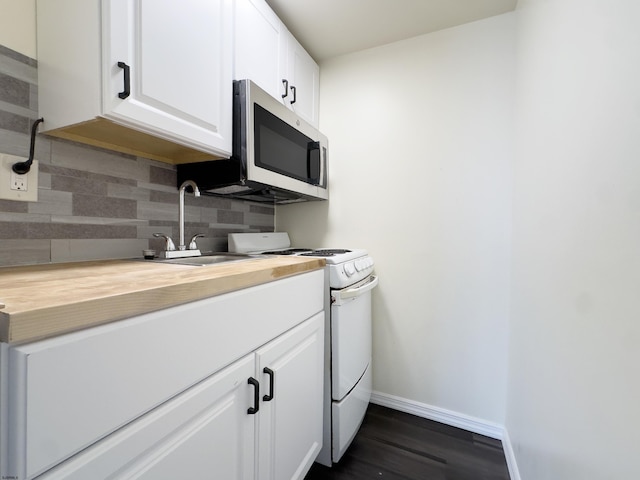 kitchen featuring tasteful backsplash, stainless steel microwave, white cabinets, white range with gas cooktop, and a sink