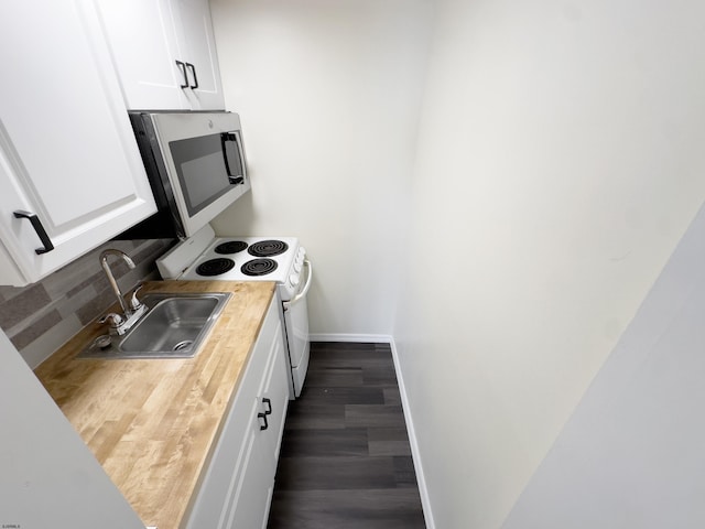 kitchen featuring tasteful backsplash, white electric stove, white cabinets, stainless steel microwave, and a sink