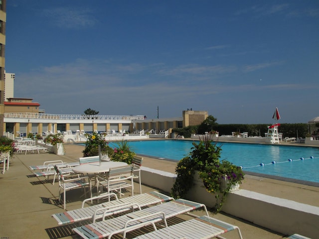 community pool with a patio area