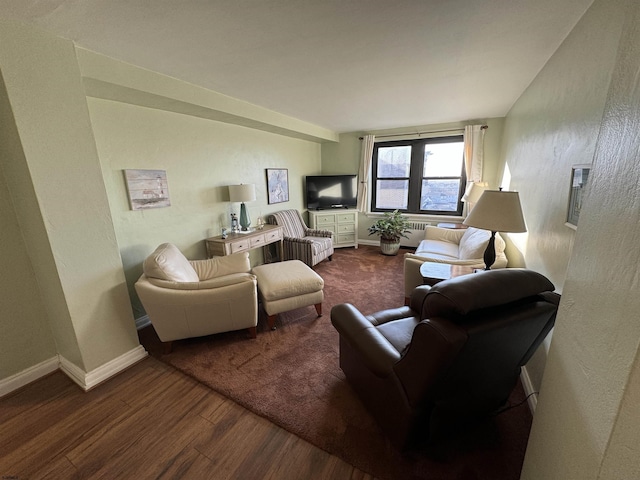 living area with wood finished floors and baseboards