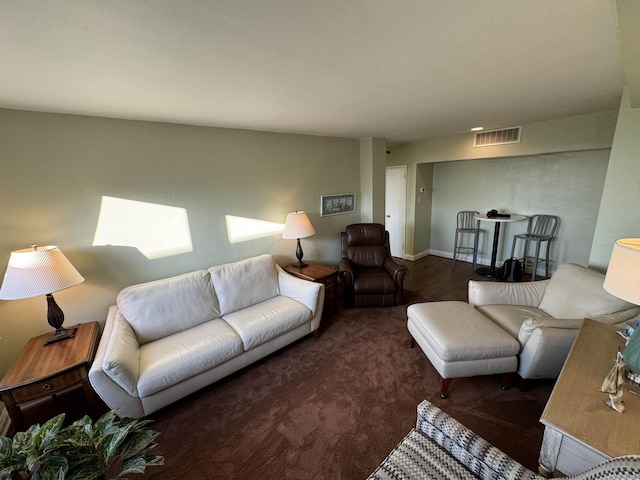 carpeted living area with visible vents and baseboards