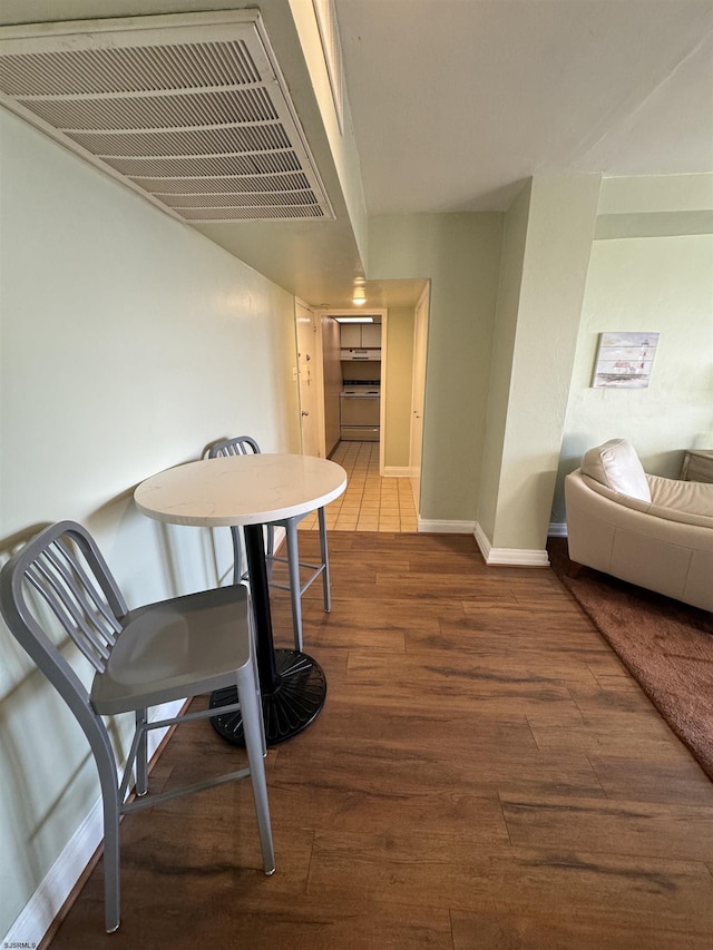 dining space with visible vents, baseboards, and wood finished floors