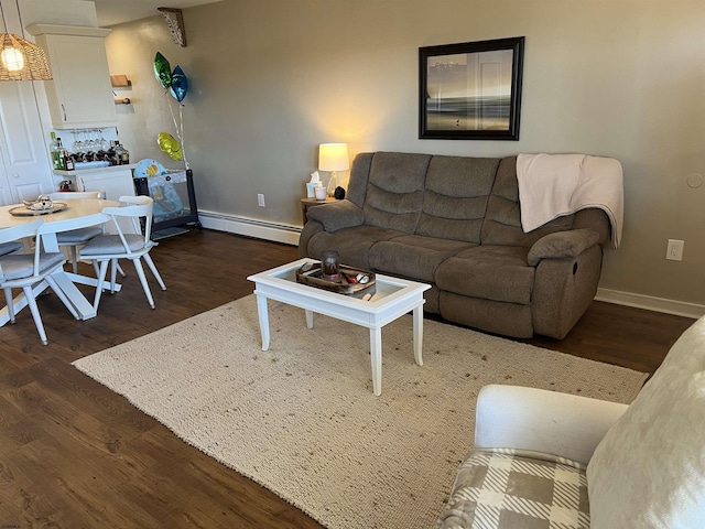 living room featuring dark wood-type flooring, baseboard heating, and baseboards