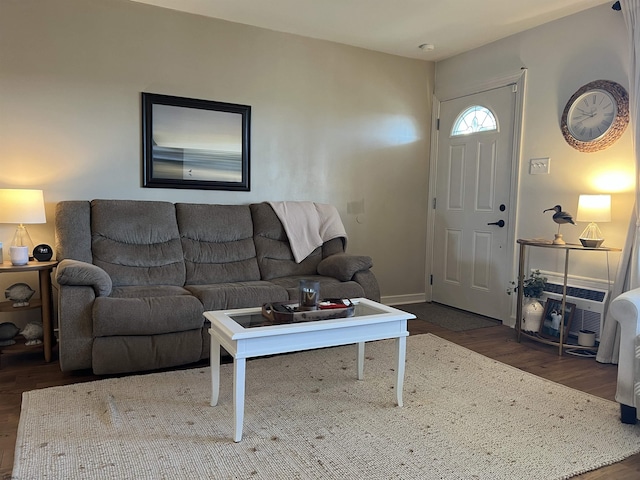 living room featuring baseboards and wood finished floors