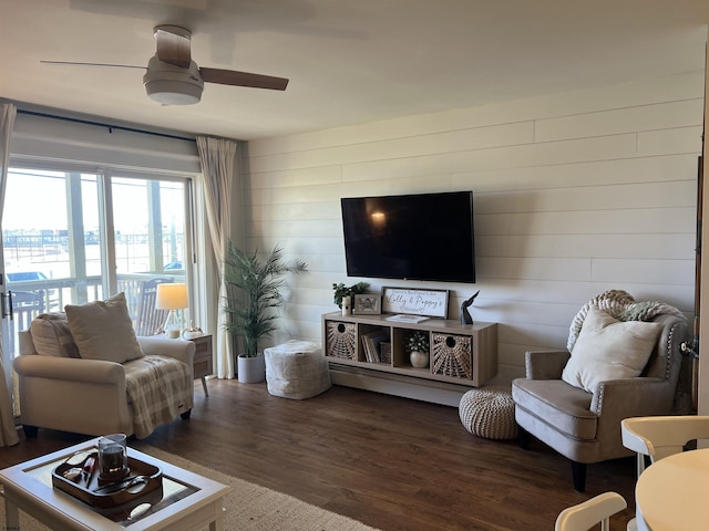 living area with ceiling fan and wood finished floors