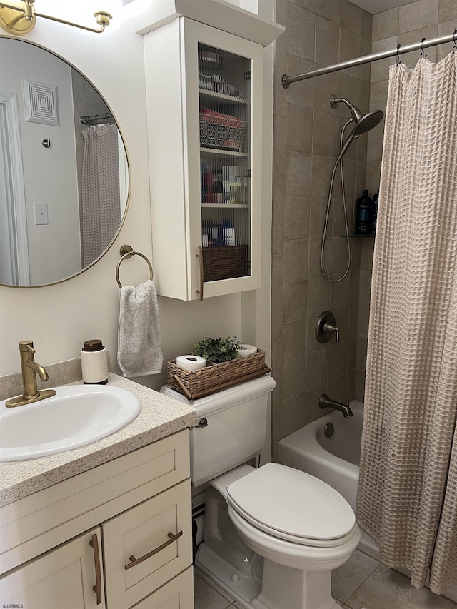 bathroom with vanity, shower / bath combo with shower curtain, toilet, and tile patterned floors