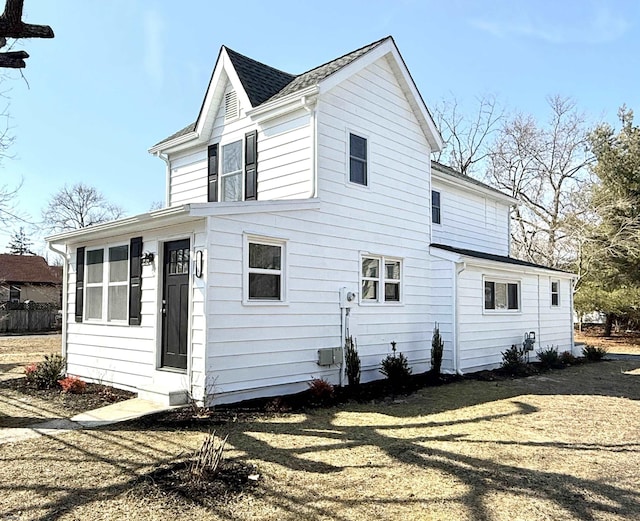 back of property featuring a shingled roof