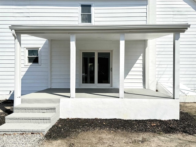 property entrance featuring a patio area