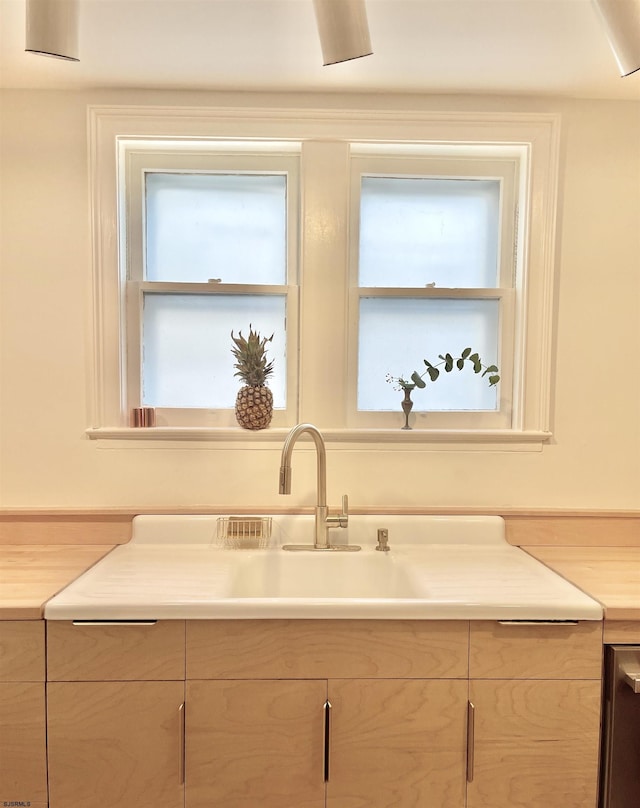 kitchen with light brown cabinets and light countertops