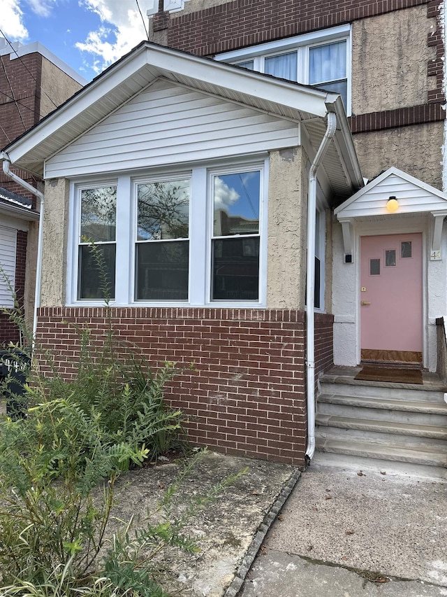 property entrance with brick siding