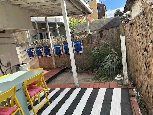 view of patio / terrace featuring fence