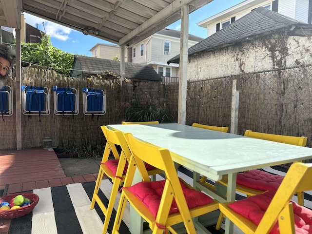 view of patio / terrace featuring outdoor dining area and fence