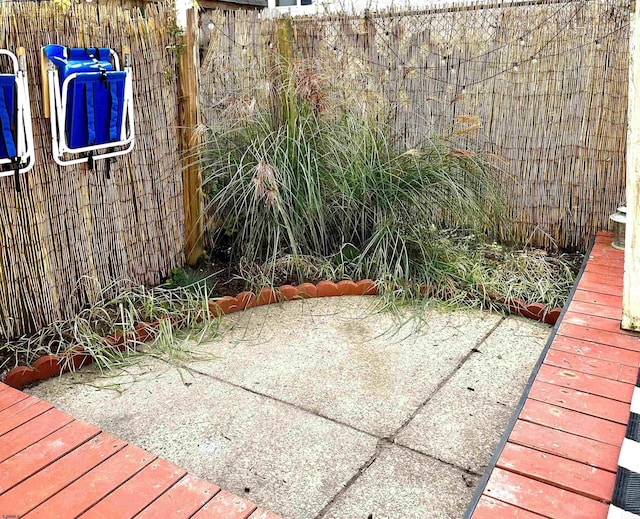 view of patio / terrace featuring fence