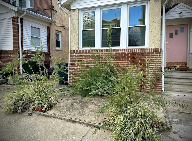 property entrance featuring brick siding