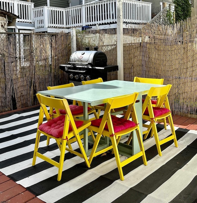 view of patio with outdoor dining area and grilling area