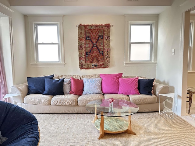 living room with baseboards and visible vents