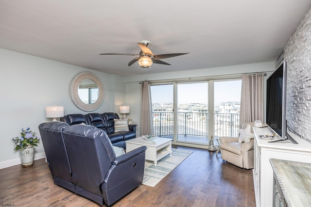 living area with dark wood-style floors, ceiling fan, and baseboards