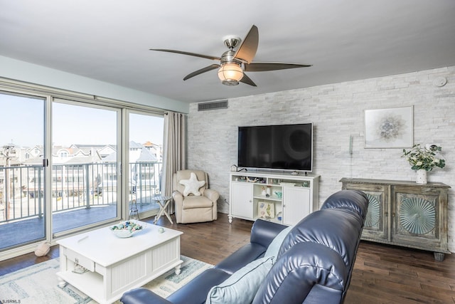 living room with a ceiling fan, visible vents, and wood finished floors