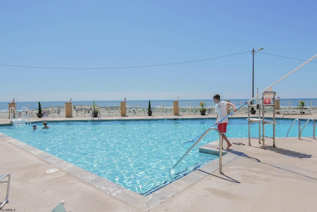 community pool with a water view and a water play area