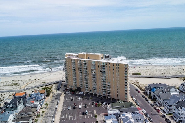 birds eye view of property featuring a water view and a view of the beach