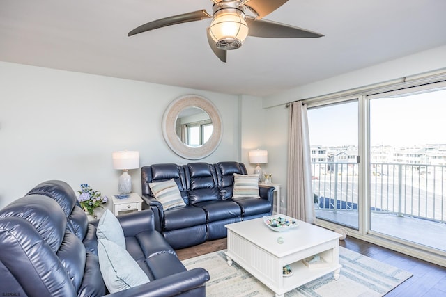 living area featuring light wood-style flooring and a ceiling fan