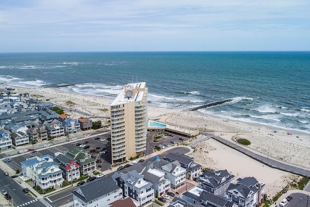 drone / aerial view with a water view and a view of the beach