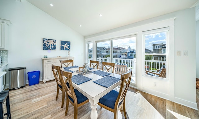 dining space featuring vaulted ceiling, recessed lighting, baseboards, and light wood-style floors