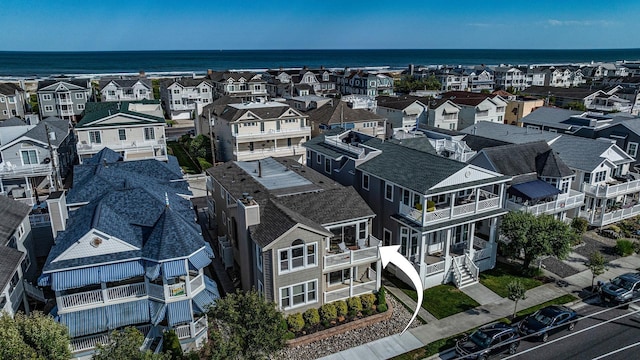 drone / aerial view with a residential view and a water view