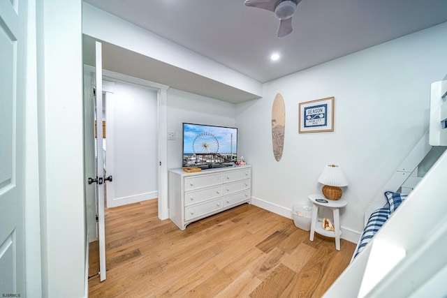 hall featuring light wood-style flooring and baseboards