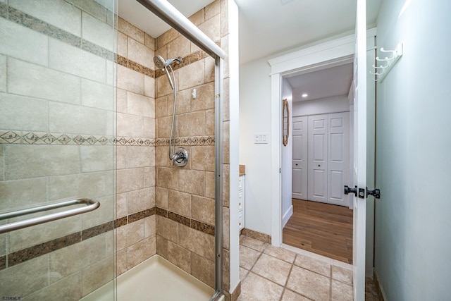 full bathroom featuring a stall shower and baseboards