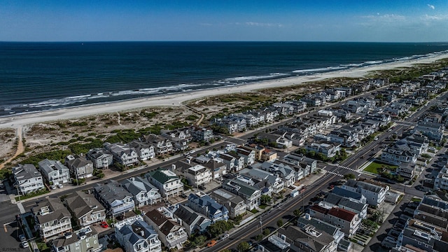 drone / aerial view with a water view and a beach view