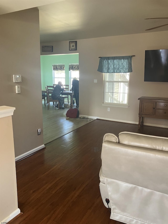 living room with baseboards and wood finished floors