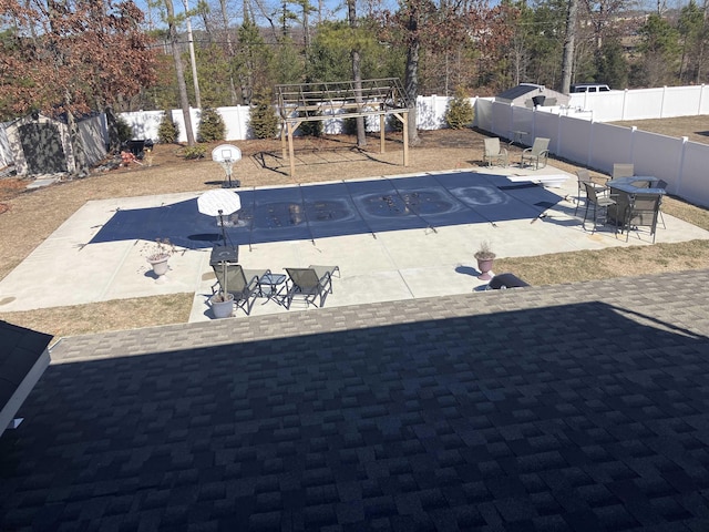 view of swimming pool with a fenced backyard, a fenced in pool, and a patio