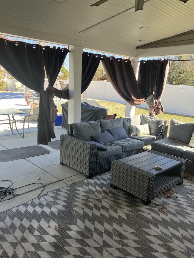 view of patio featuring an outdoor living space and fence
