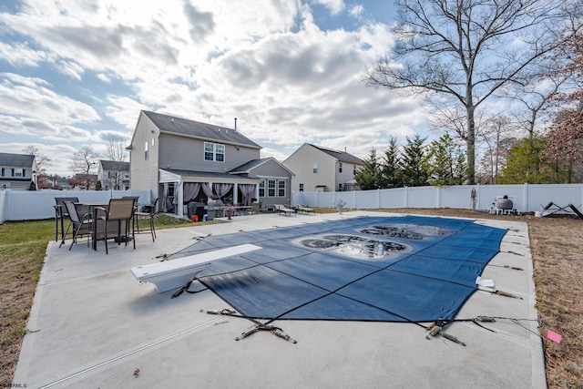 view of swimming pool with a patio, outdoor dining area, a fenced backyard, and a fenced in pool
