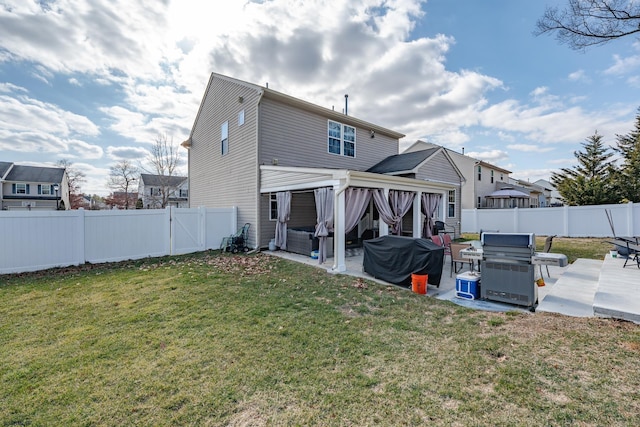 back of property with a fenced backyard, a lawn, and a patio area