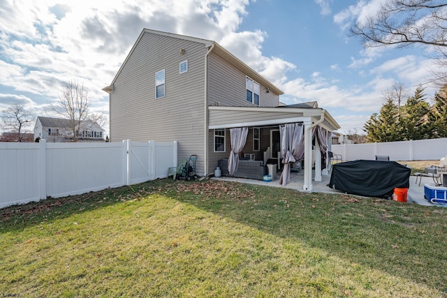 back of property with a fenced backyard, a patio, and a yard