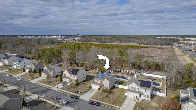 aerial view with a wooded view and a residential view
