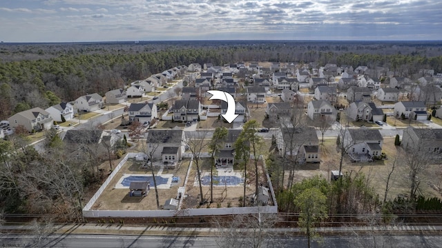 aerial view with a residential view and a wooded view
