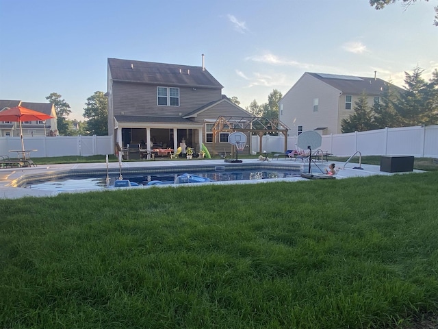 view of swimming pool featuring a fenced backyard, a fenced in pool, a patio, and a lawn
