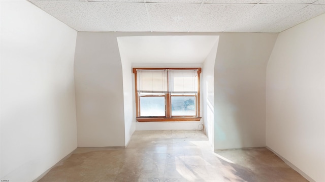 unfurnished room featuring concrete floors and a paneled ceiling