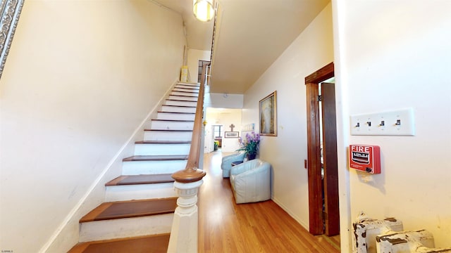 stairs featuring wood finished floors