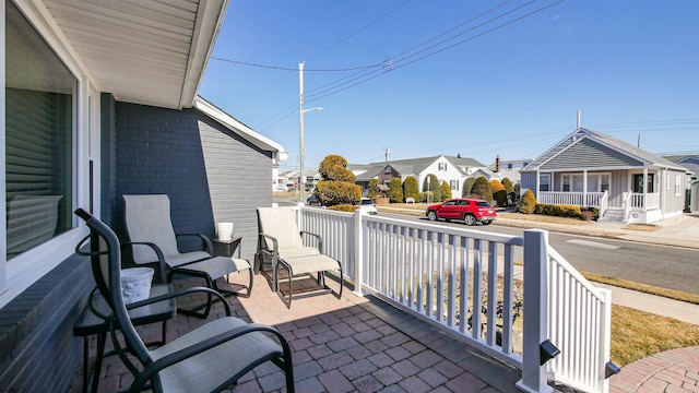 view of patio / terrace featuring a porch and a residential view