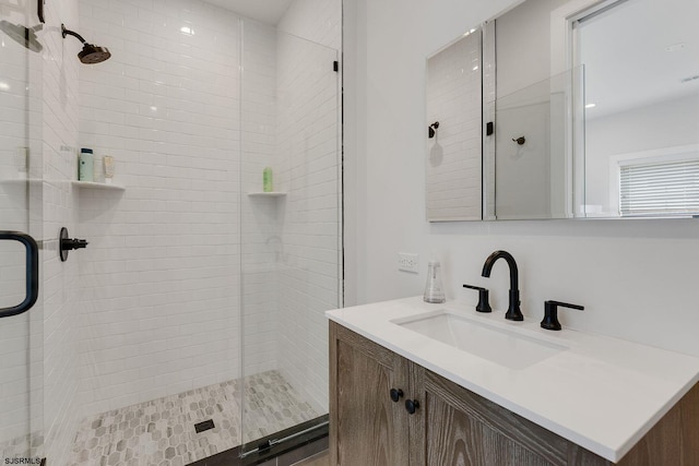 bathroom featuring a shower stall and vanity