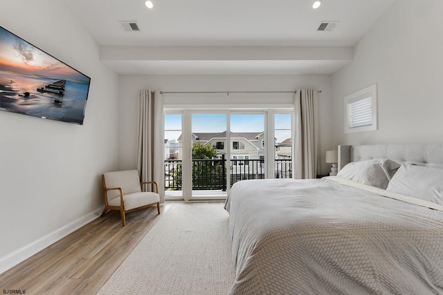 bedroom featuring access to exterior, light wood finished floors, visible vents, and baseboards