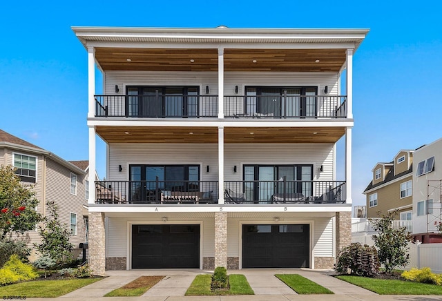 view of front of house with a garage, a balcony, and concrete driveway