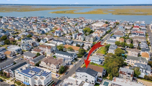 bird's eye view featuring a water view and a residential view